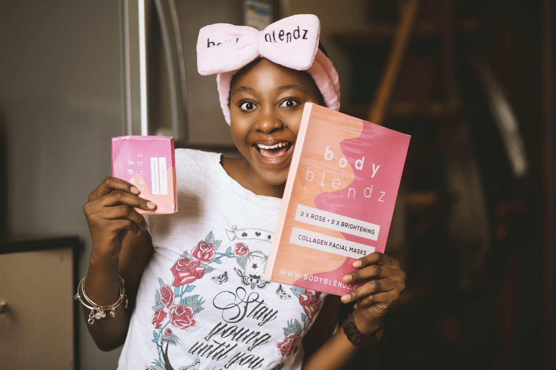 woman holding book and pink box